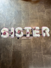 Sister tribute with corsage sprays